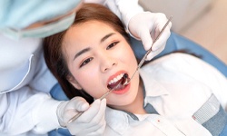 person getting their teeth cleaned by a dentist