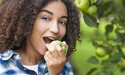 Young girl eating an apple