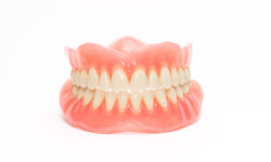 Full set of dentures with white background