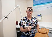 Smiling team member in dental chair