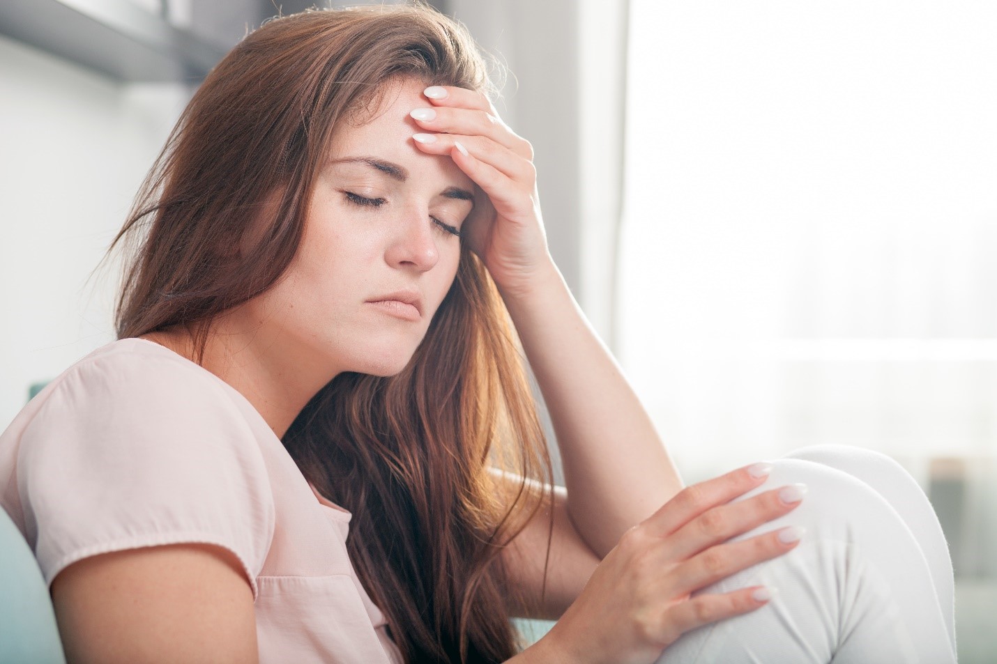 tired woman with headache - Kirlough Family Dentistry Blog