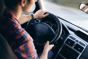 Man in car experiencing drowsy driving.