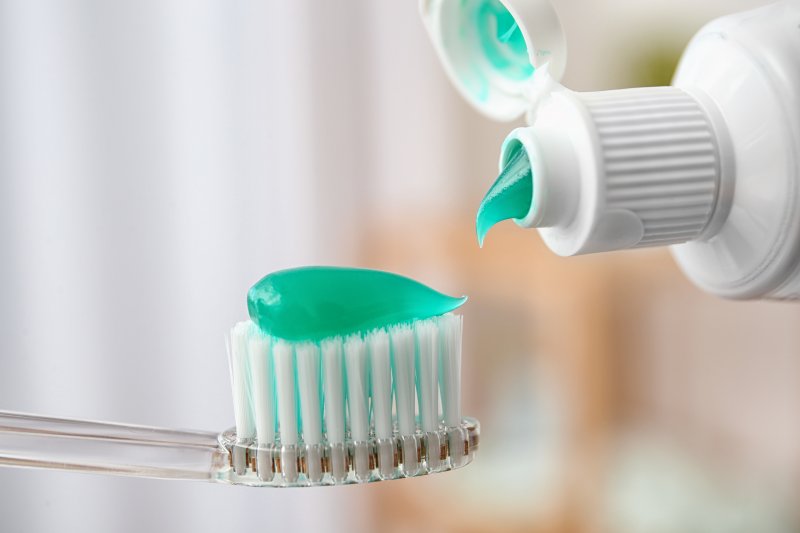 A closeup of fluoridated toothpaste on a toothbrush