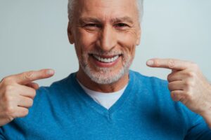 Senior showing off dentures.