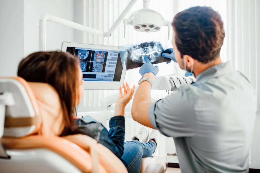 Dentist showing woman her X-rays