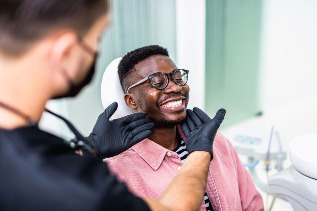 A man smiling after getting a dental crown